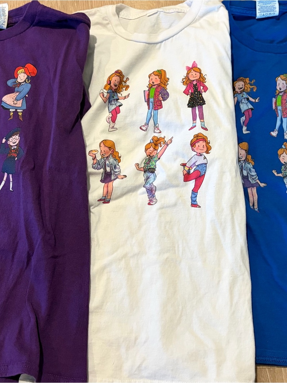 Girls graphic tees with American Girl doll prints